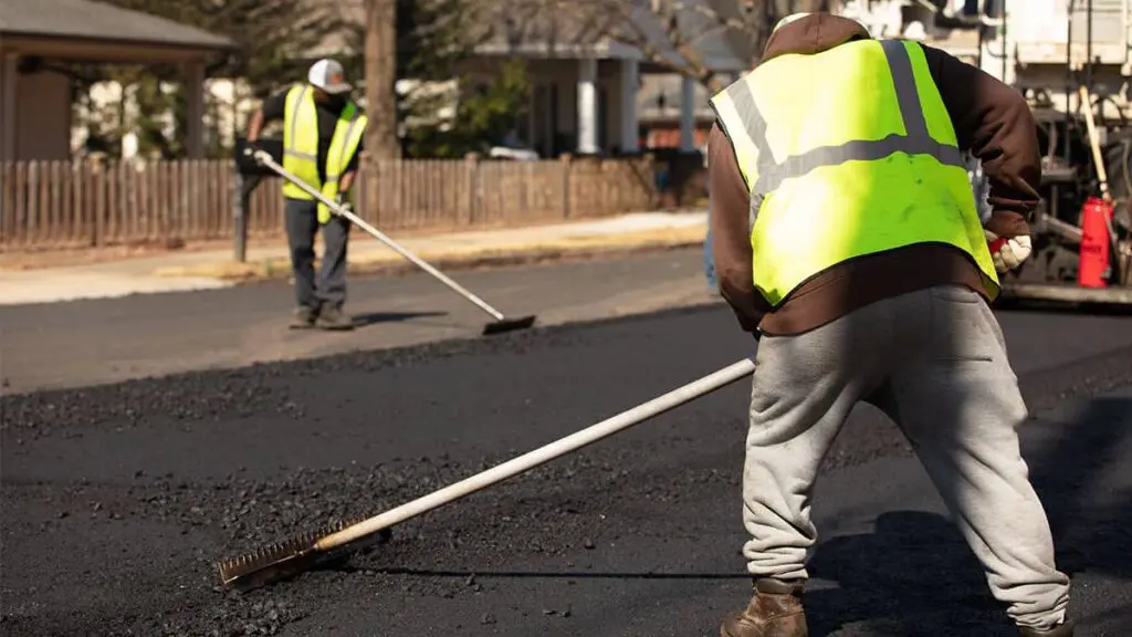 magnum paving employees raking asphalt