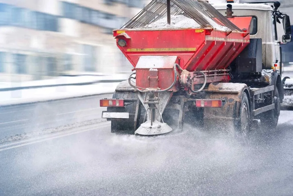truck spreading salt on the road