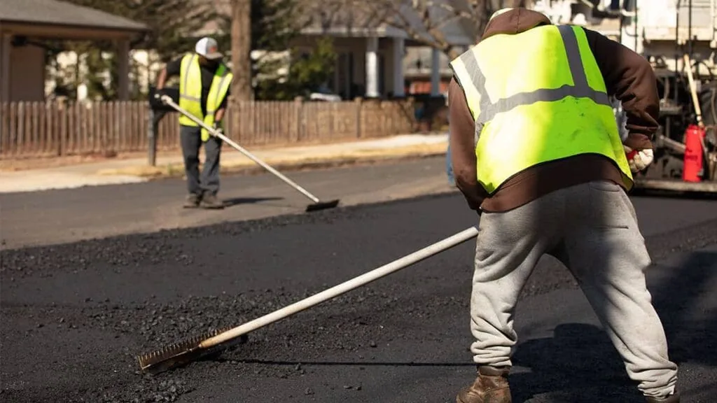 magnum paving employees raking asphalt