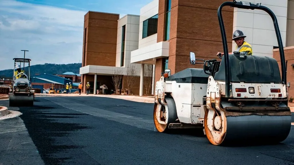 person driving an asphalt roller