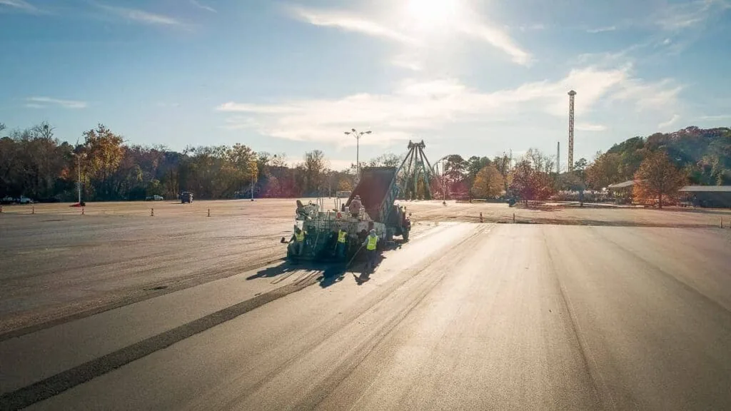 magnum paving employees paving a six flags parking lot