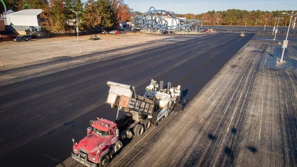 red magnum paving truck working on six flags
