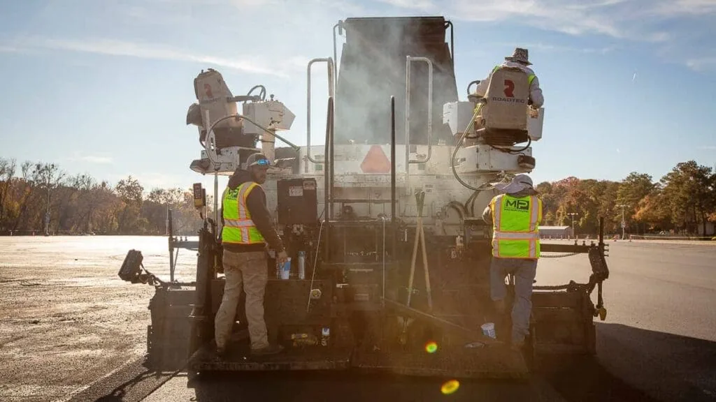 magnum paving employees on machine