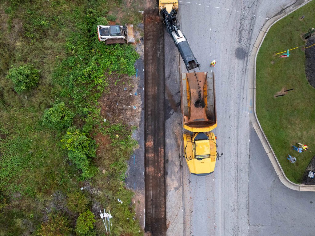 birdseye view of magnum paving employees working on the side of the road