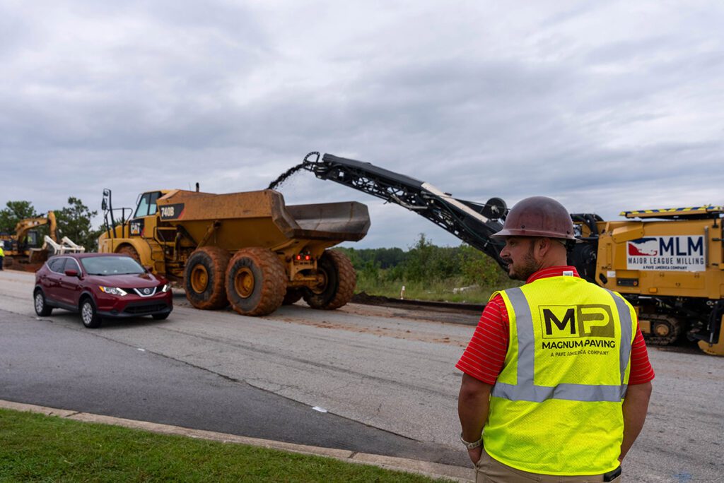 magnum paving employee and a cold planer machine