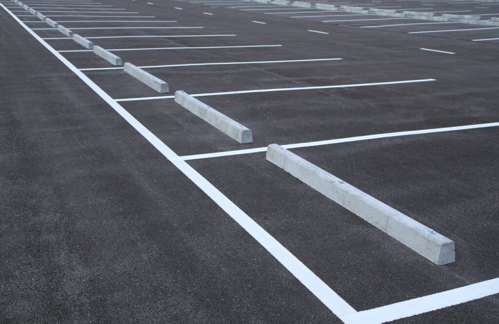 freshly painted parking lot with curb stops