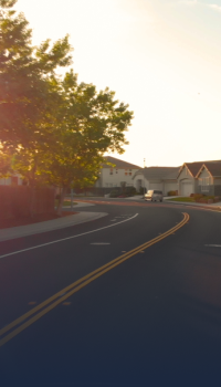 winding road in front of a row of houses